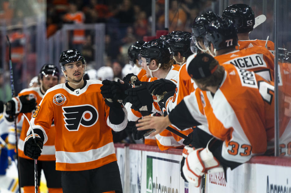 Philadelphia Flyers' Morgan Frost, left, is congratulated for his goal against the Buffalo Sabres during the first period of an NHL hockey game Saturday, April 1, 2023, in Philadelphia. (AP Photo/Chris Szagola)