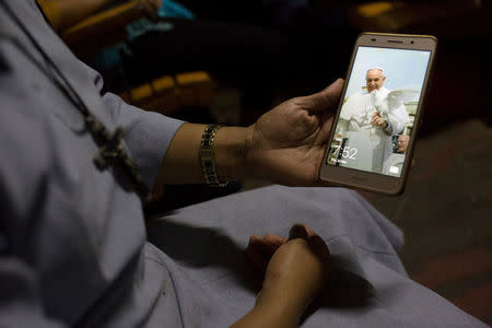 A Catholic nun from Kachin state show a picture of Pope Francis on her mobile phone while traveling on a two-day train trip from Myitkyina to Yangon to attend the pope's visit to Myanmar next week, November 23, 2017. REUTERS/Ann Wang