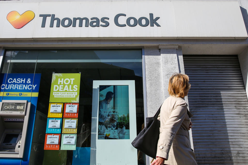  A woman walks past a branch of Thomas Cook in central London. Thomas Cook collapsed under a pile of debt after talks with creditors failed, forcing the British government to charter planes to bring home more than 150,000 of the storied travel providers stranded customers. (Photo by Dinendra Haria / SOPA Images/Sipa USA) 