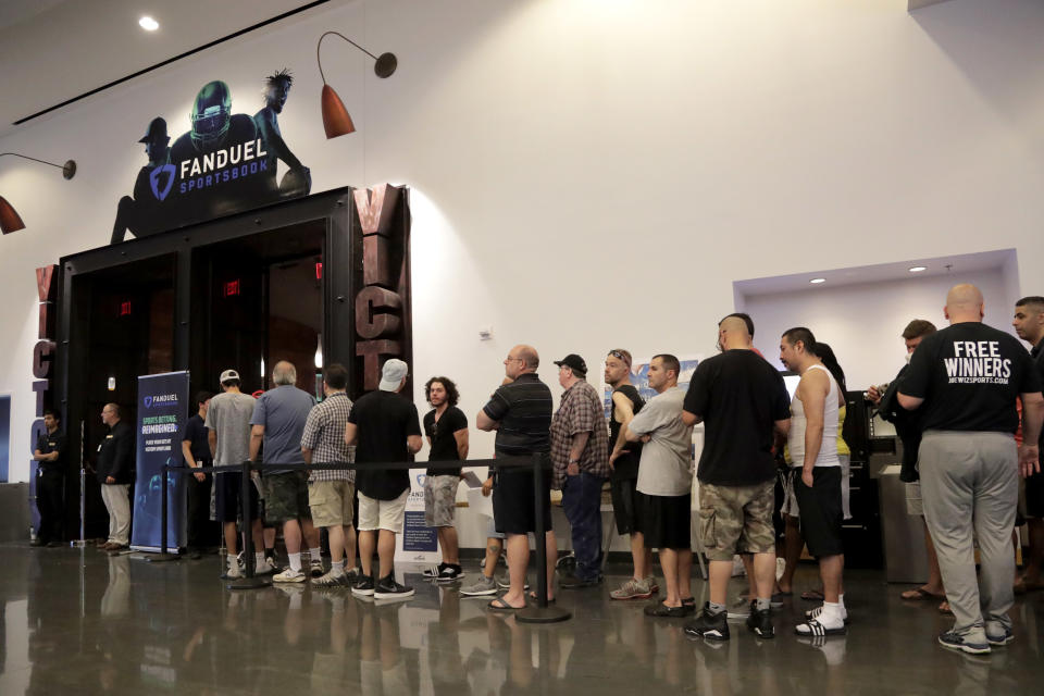 People wait in line to enter the FanDuel Sportsbook at the Meadowlands Racetrack in East Rutherford, N.J., on July 14, 2018. (AP Photo/Julio Cortez)