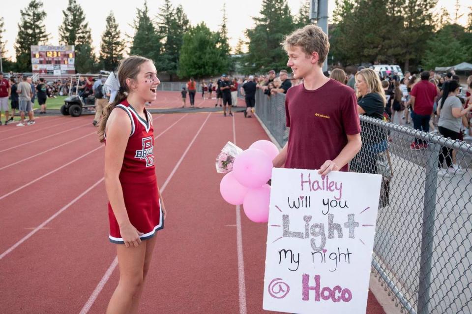 Bear River High School student Ethan Perrine, right, surprises Hailey Heer asking her to homecoming before the game against Tamalpais High School on Sept. 14.