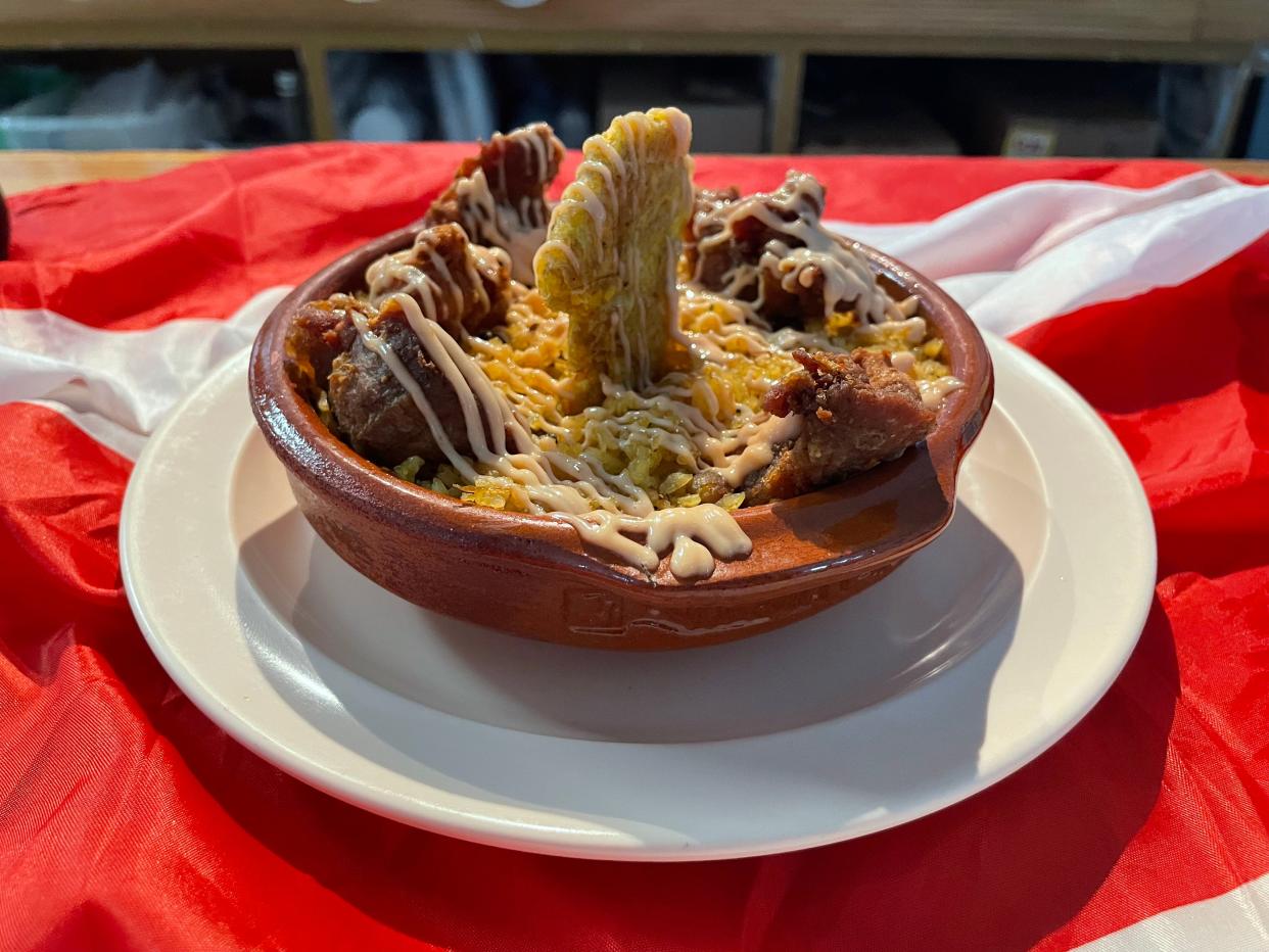 The Coqui Bowl, served on Isla del Coqui in Greenacres, is a twist on Mofongo, a typical Puerto Rican plate.  The stacked bowl contains mashed potatoes, green plantains, yellow rice, chicken pieces, a plantain topped with a signature pink "Coqui" sauce.