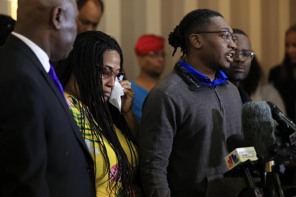 Quantavius Laguerre, right, brother of Anolt "AJ" Laguerre Jr., speaks as his grandmother Cheryl Joachin wipes a tear during Tuesday's news briefing in Jacksonville. Family members of the three lost in a racially motivated shooting in August, Laguerre, Ashley Carr and Jerrald Gallion, filed a lawsuit against Dollar General and others involved.