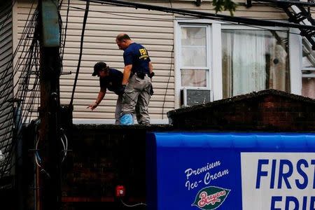 Federal Bureau of Investigation (FBI) personnel search an address during an investigation into Ahmad Khan Rahami, who was wanted for questioning in an explosion in New York, which authorities believe is linked to the explosive devices found in New Jersey, in Elizabeth, U.S., September 19, 2016. REUTERS/Eduardo Munoz