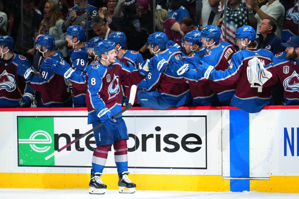 Colorado Avalanche defenseman Cale Makar (8) is congratulated for his goal against the Tampa Bay Lightning during the third period in Game 5 of the NHL hockey Stanley Cup Final, Friday, June 24, 2022, in Denver. (AP Photo/Jack Dempsey)
