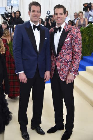 <p>Theo Wargo/Getty</p> Cameron and Tyler Winklevoss attend the 2017 Met Gala