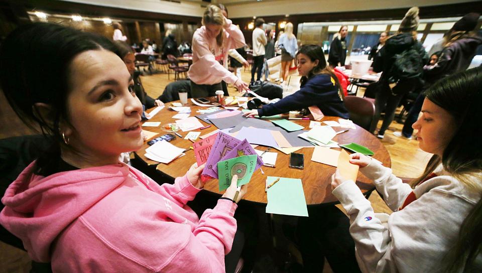 Iowa State University students show holiday cards they created for children battling cancer and other serious illnesses at the University's Memorial Hall building on Tuesday, Nov. 28, 2023, in Ames, Iowa.