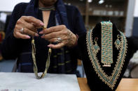 A woman adjusts hand-made jewellery she made during a Christmas workshop to teach embroidery and handicrafts in the northern Israeli city of Nazareth, December 6, 2018. Picture taken December 6, 2018. REUTERS/Ammar Awad