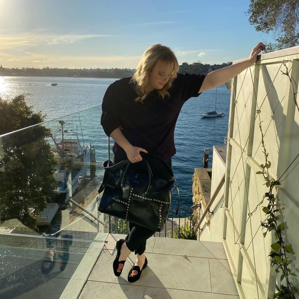 Rebel Wilson poses in front of Sydney harbour