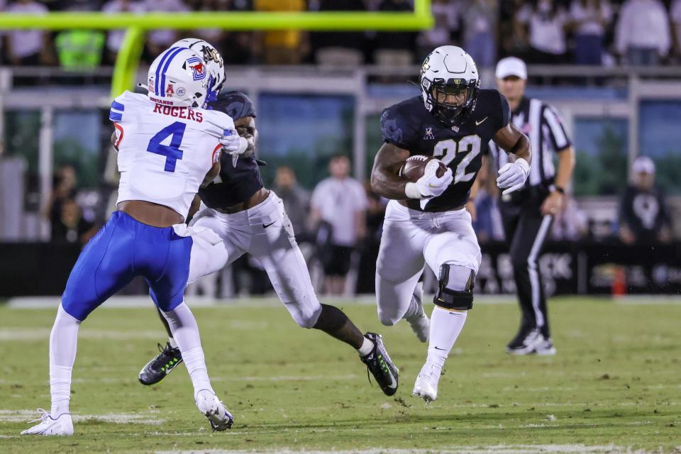 Oct 5, 2022; Orlando, Florida, USA; UCF Knights running back RJ Harvey (22) carries the ball during the second half against the Southern Methodist Mustangs at FBC Mortgage Stadium. Mandatory Credit: Mike Watters-USA TODAY Sports
