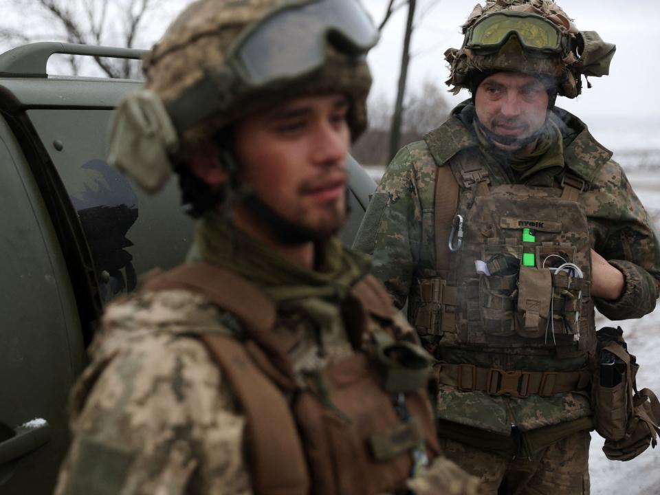 Ukrainian soldiers stand on a road close to Soledar on January 14 amid the Russian invasion of Ukraine.