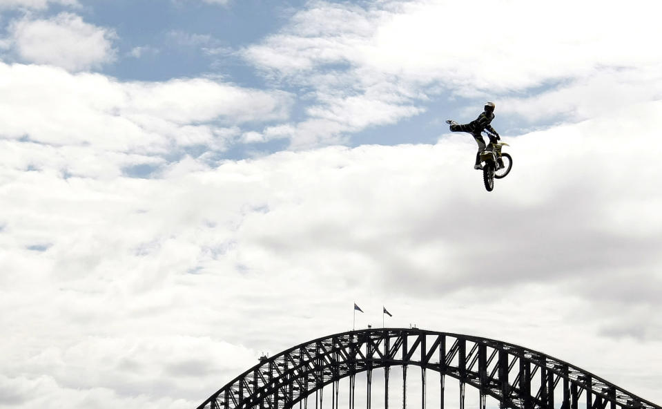 Motorcross rider Travis Pastrana of the U.S. jumps his bike in front of the Sydney Harbour Bridge October 28, 2009. Pastrana performed the stunt to promote a new television show. REUTERS/Tim Wimborne