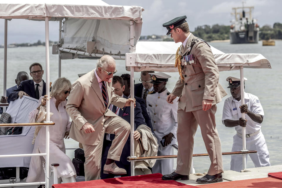 Britain's King Charles III, center, followed by Queen Camilla arrive aboard the Admiral's Barge to meet Royal Marines and Kenyan Marines at Mtongwe Naval Base, in Mombasa, Kenya, Thursday, Nov. 2, 2023. (Luis Tato/Pool Photo via AP)