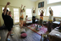 Members of a prenatal group at The Farm Midwifery Center dance during a meeting Thursday, Aug. 31, 2023, in Summertown, Tenn. Led by midwife Corina Fitch, the women shared thoughts and concerns. (AP Photo/George Walker IV)