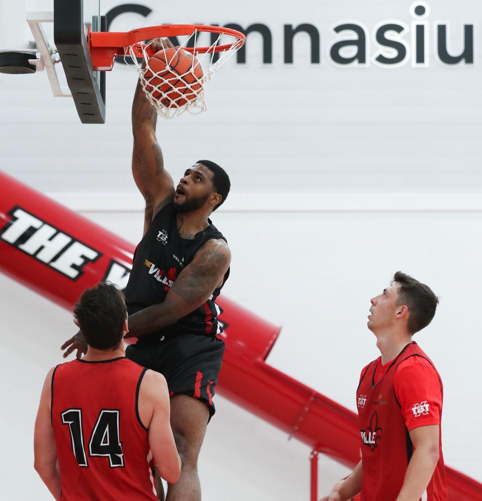 Former U of L basketball player Chane Behanan dunks during The Ville's practice at the Kueber Center in Louisville, Ky. on July 18, 2023.