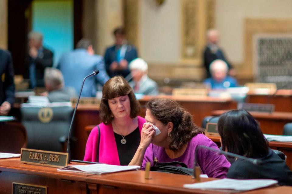 Kentucky Sen. Karen Berg, D-Louisville, is consoled by former state legislator Patti Minter, left, and Rep. Tina Bojanowski, D-Louisville, after SB 150 passed the Senate, 29-6, at the Kentucky state Capitol on Thursday, Feb. 16, 2023. The bill would allow teachers to choose whether or not to use a student’s pronouns. Berg’s transgender son died by suicide in December.