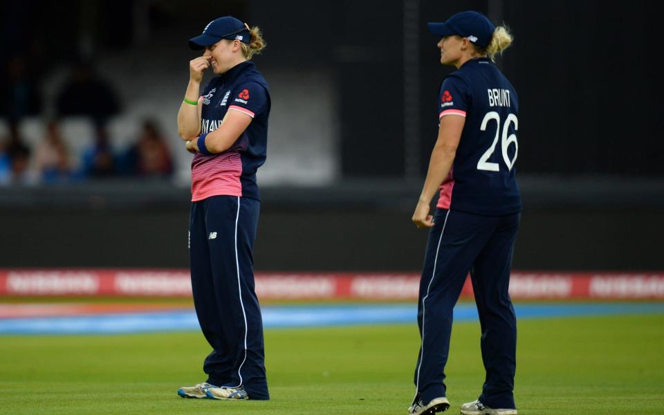 Heather Knight and Katherine Brunt look on anxiously as India close in on their target - Credit: Getty