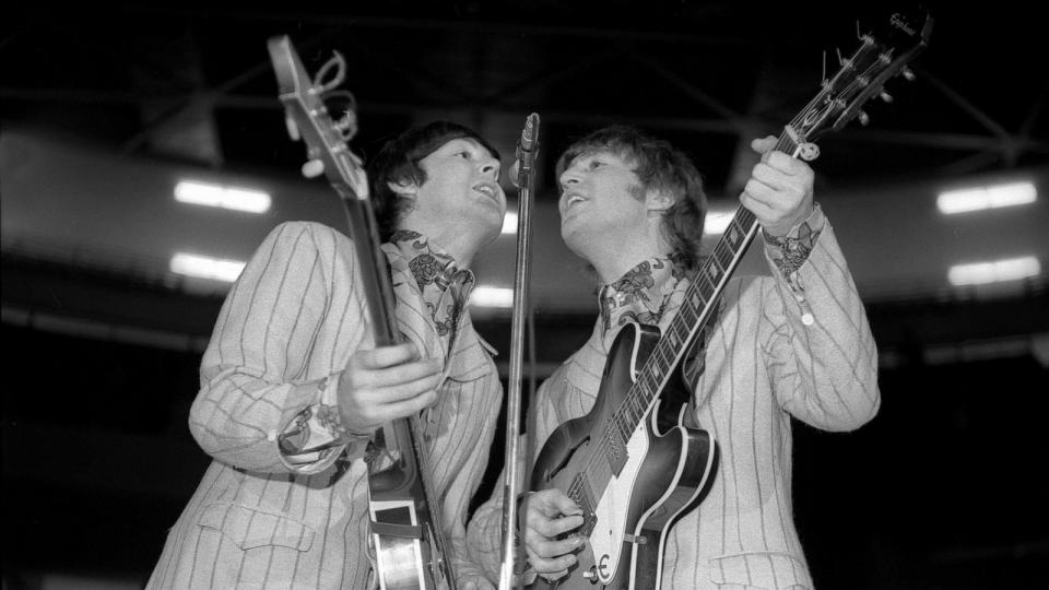 PHOTO: English Rock and Pop musicians Paul McCartney, left, on bass, and John Lennon, on guitar, perform with the Beatles in Detroit, Aug. 13, 1966. (Douglas Elbinger/Getty Images)
