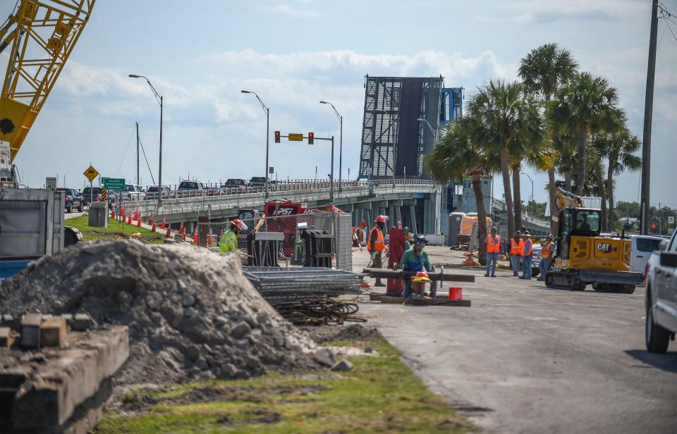 Construction workers begin work for the new North Causeway Bridge at North Causeway Island Park as the current drawbrige is open for boat traffic on Tuesday, May 9, 2023, in Fort Pierce. 