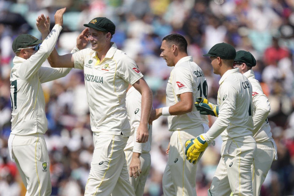 Australia's Cameron Green, second left celebrates with teammates including Australia's Scott Boland, center, after he caught India's Shubman Gill out off the bowling of Boland, on the fourth day of the ICC World Test Championship Final between India and Australia at The Oval cricket ground in London, Saturday, June 10, 2023. (AP Photo/Kirsty Wigglesworth)