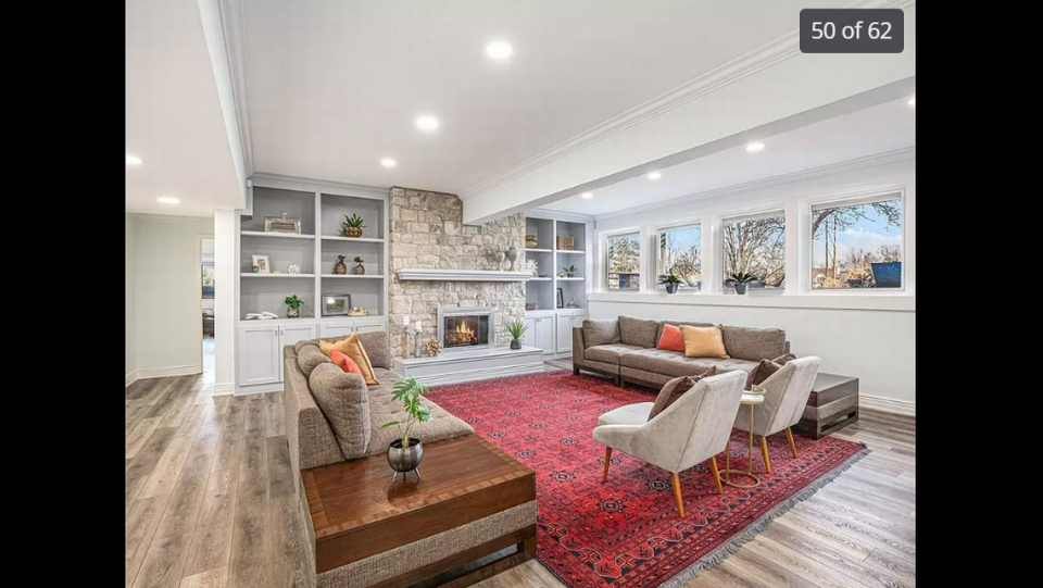 One of many lounging areas inside the home at 15525 Switzer Road in Overland Park. The lower level area gives visitors a peek at the backyard scenery. Zillow