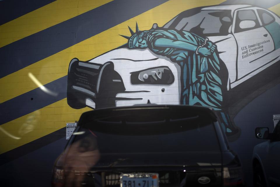 A car is parked in front of a mural in downtown Las Vegas, Tuesday, Nov. 10, 2020. For decades, the working-class neighborhoods that circle Las Vegas called out to foreigners, who came from dozens of other countries, especially Mexico. They changed Las Vegas and Nevada. One in five of the state's residents are immigrants, according to the American Immigration Council, and one in six are native-born citizens with at least one immigrant parent. (AP Photo/Wong Maye-E)
