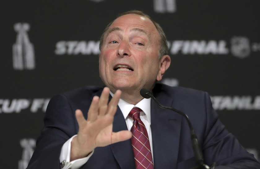 FILE - In this May 27, 2019, file photo, NHL Commissioner Gary Bettman speaks to the media before Game 1 of the NHL hockey Stanley Cup Final between the St. Louis Blues and the Boston Bruins in Boston. Bettman said getting to those quarantined bubbles and resuming play are just two more steps in the process with the goal of awarding the Stanley Cup in late September or early October. (AP Photo/Charles Krupa, File)