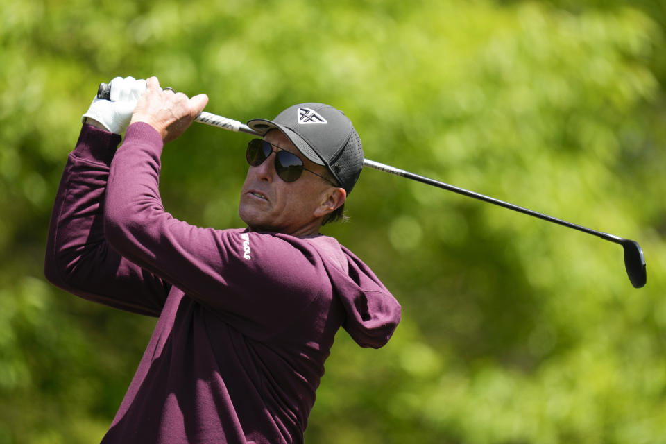 Phil Mickelson watches his tee shot on the third hole during a practice round for the PGA Championship golf tournament at Oak Hill Country Club on Wednesday, May 17, 2023, in Pittsford, N.Y. (AP Photo/Seth Wenig)