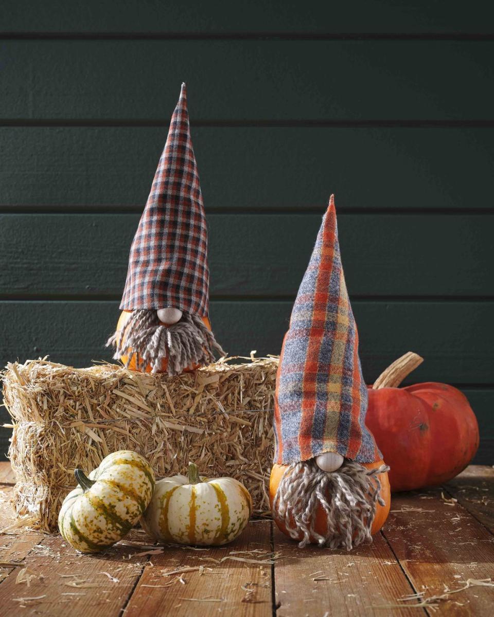 <p>Keep those garden gnomes company with these warm and fuzzy pumpkin friends.</p><p><strong>Make the pumpkin:</strong> Trace hat <a href="https://hmg-prod.s3.amazonaws.com/files/gnomehat-1592336643.pdf?tag=syn-yahoo-20&ascsubtag=%5Bartid%7C10050.g.28437255%5Bsrc%7Cyahoo-us" rel="nofollow noopener" target="_blank" data-ylk="slk:template;elm:context_link;itc:0;sec:content-canvas" class="link ">template</a> on wool fabric, adjusting size as necessary; cut out. Use craft glue or iron-on fusible tape to glue straight edges together. Fill hat with batting to help it stand upright; set on pumpkin. Attach a small wood craft bead to a small pumpkin with hot-glue to create a nose. Attach strands of yarn with hot glue around nose to create beard; trim as necessary. </p>