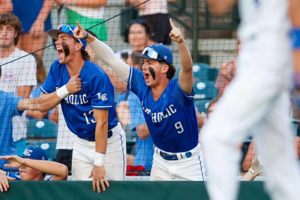 Jack White, left, and Tyler Nighbert cheer after a run is scored during Lexington Catholic’s 6-0 win against Mason County on Thursday at Legends Field.