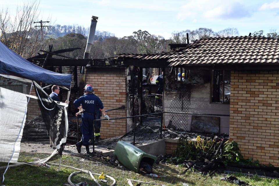 Fire investigators and forensic services at the scene of the house fire in Batlow. source: AAP