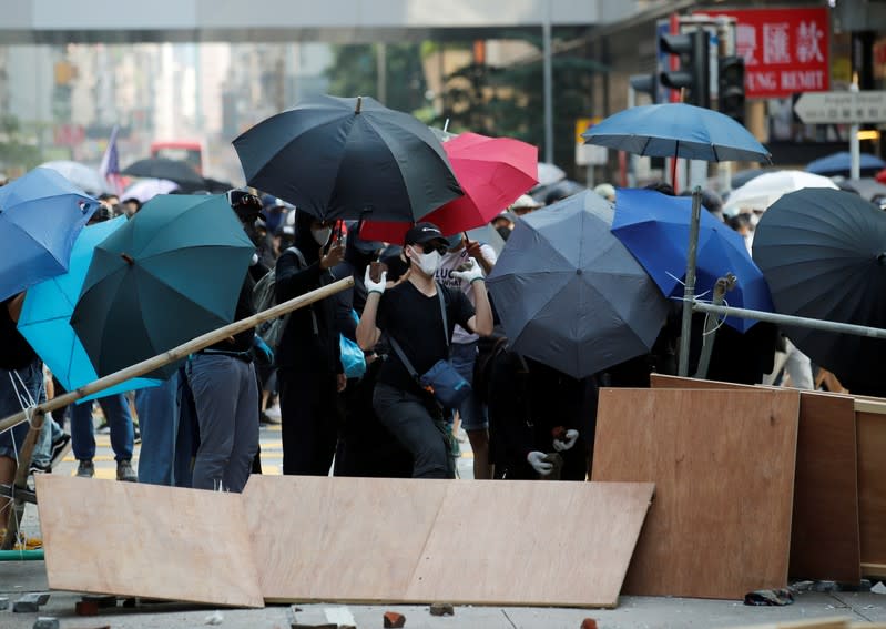 Anti-government demonstrators build a barricade during a protest march in Hong Kong