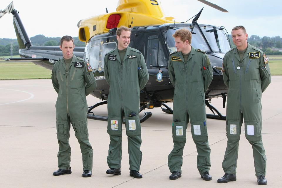 TRH Prince William and Prince Harry pose with their trainers (r) Daz Mitchell and (l) Craig Finch in front of a Griffin helicopter during a photocall at RAF Shawbury on June 18, 2009 in Shrewsbury, England.