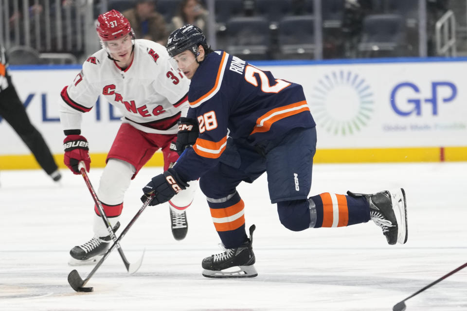 New York Islanders defenseman Alexander Romanov (28) skates against Carolina Hurricanes right wing Andrei Svechnikov (37) during the second period of an NHL hockey game, Saturday, Jan. 21, 2023, in Elmont, N.Y. (AP Photo/Mary Altaffer)