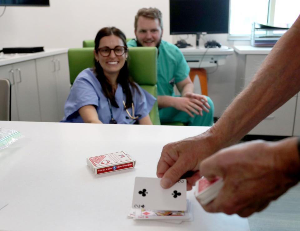 Retired gastroenterologist Gary Poleynard, performs a card trick for medical residents as he visits patients at the Memorial Health Dwaine and Cynthia Willett Children’s Hospital of Savannah on Friday, October 13, 2023.