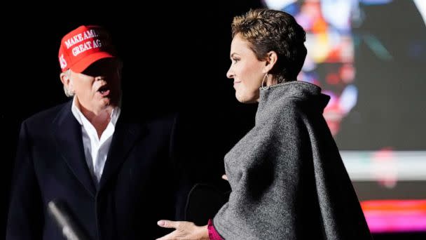 PHOTO: Former President Donald Trump, left, introduces Arizona Republican candidate for governor Kari Lake, right, as Trump speaks at a rally on Jan. 15, 2022, in Florence, Ariz. (Ross D. Franklin/AP, FILE)