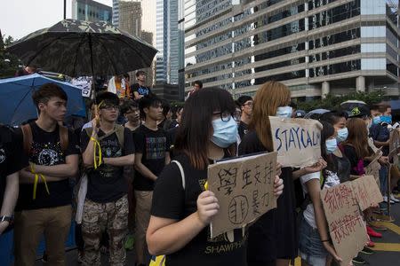 Student protesters gather outside the venue of the official flag-raising ceremony for celebrations of China's National Day, in Hong Kong October 1, 2014. REUTERS/Tyrone Siu