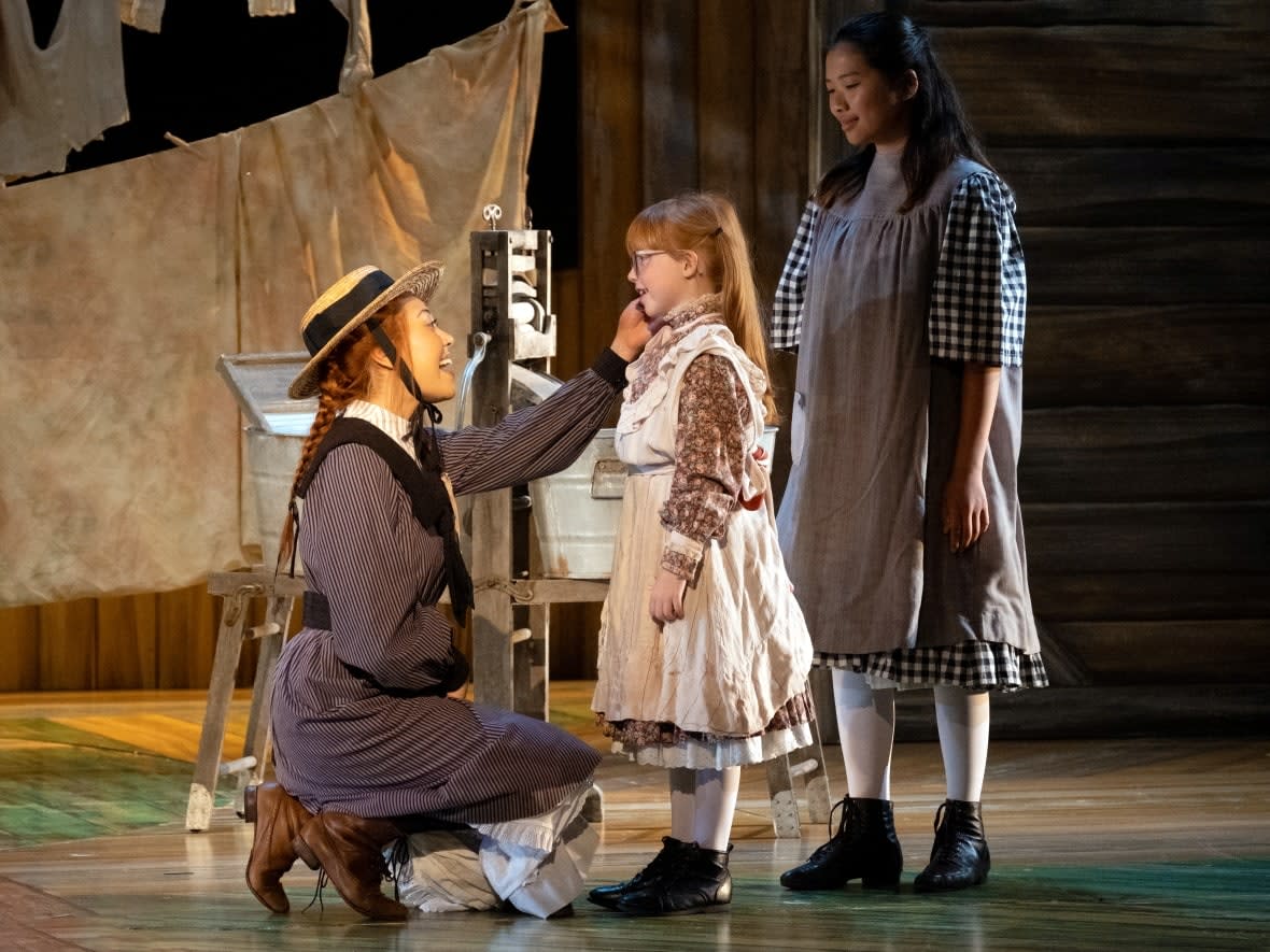 Kelsey Verzotti as Anne in the 2022 Charlottetown Festival production of Anne of Green Gables — The Musical, with Blaire Dudley and Hanaye Ono.   (Louise Vessey/Charlottetown Festival - image credit)