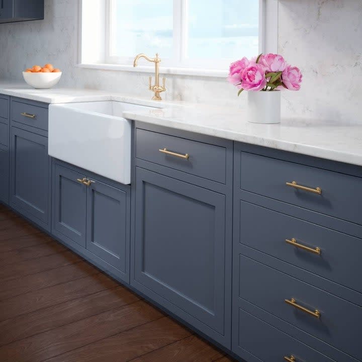 The pulls paired with navy blue cabinets