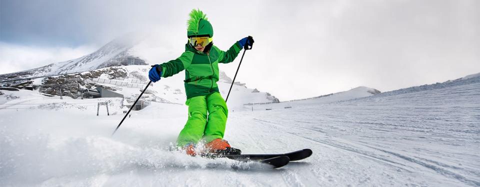 Little boy enjoying skiing at glacier in the Alps