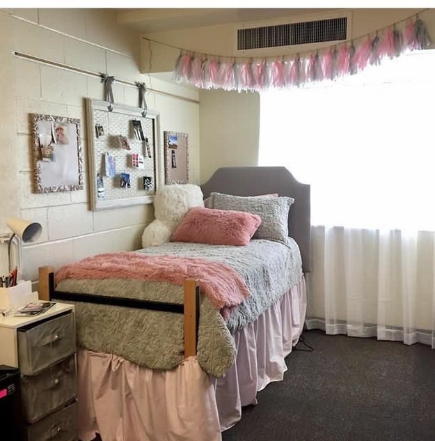 A bedroom with a twin bed and a pastel palette of light beige, pink, and blue