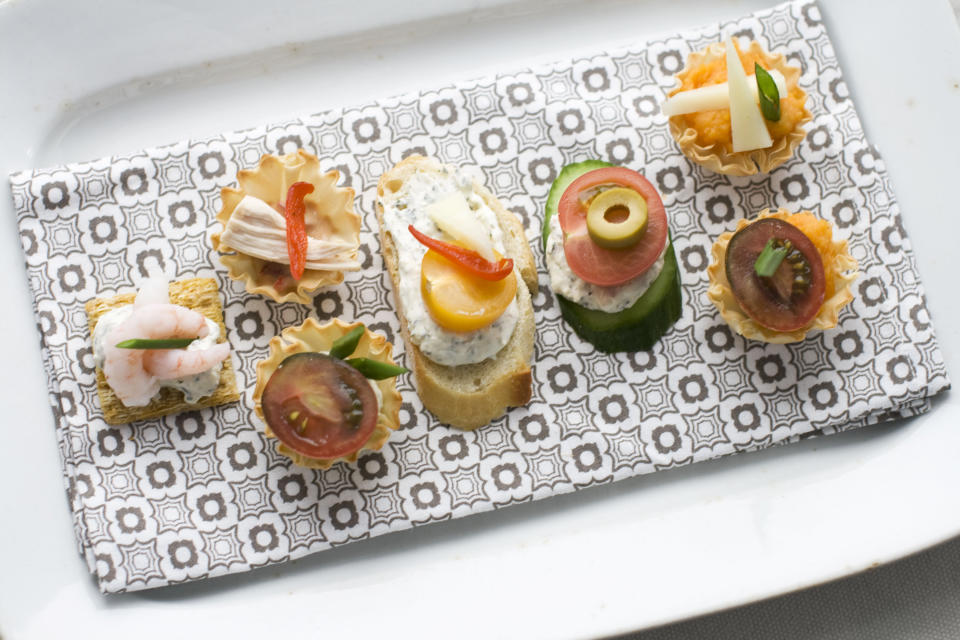 In this Jan. 28, 2013 photo, using our building block approach to Oscar party canapes, diners are able to select from a buffet of ingredients -- from bases and spreads to toppings and garnishes -- to design snacks that suit their preferences as shown on this serving tray in Concord, N.H. (AP Photo/Matthew Mead)