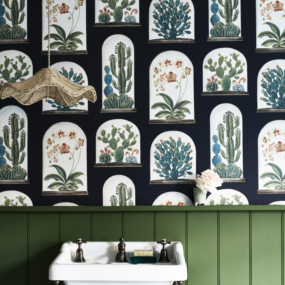 leafy motif wallpaper and green panelled wall