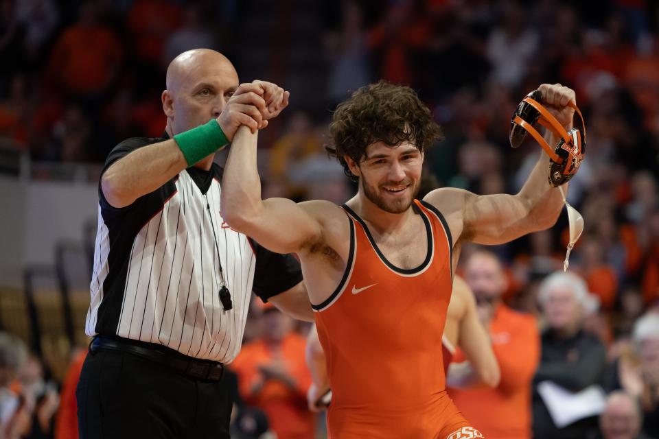 OSU wrestling Daton Fix celebrates after victory of OU's Gabe Vidlek in Bedlam on Feb. 18 at Gallagher-Iba Arena in Stillwater.