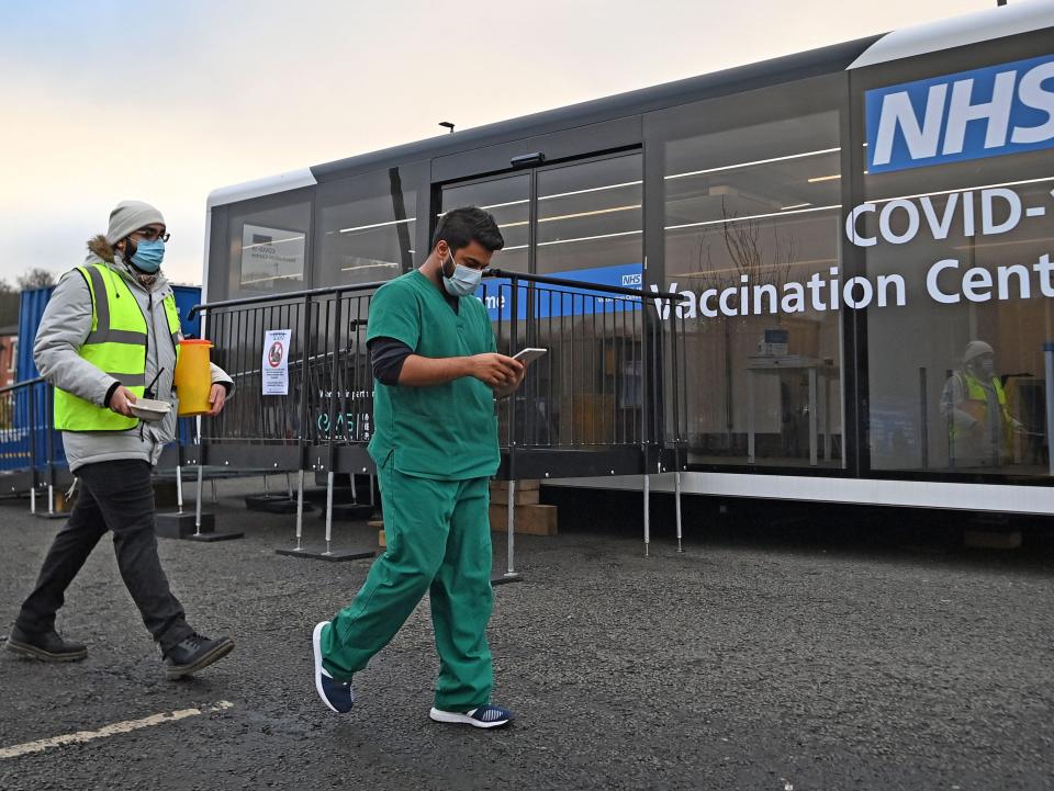NHS workers are pictured at a drive-through Covid-19 vaccination centre outside Ewood Park in Blackburn (AFP via Getty Images)