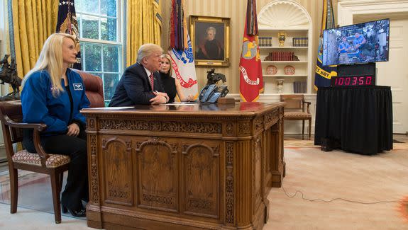 NASA astronaut Kate Rubins (left) sits with President Donald Trump and Ivanka Trump during a call to the Space Station.