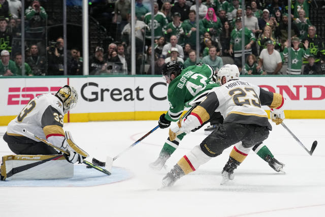 Vegas Golden Knights' Adin Hill (33) and Alec Martinez (23) defend against a shot attempt by Dallas Stars left wing Fredrik Olofsson (42) during the third period of Game 4 of the NHL hockey Stanley Cup Western Conference finals Thursday, May 25, 2023, in Dallas. (AP Photo/Tony Gutierrez)