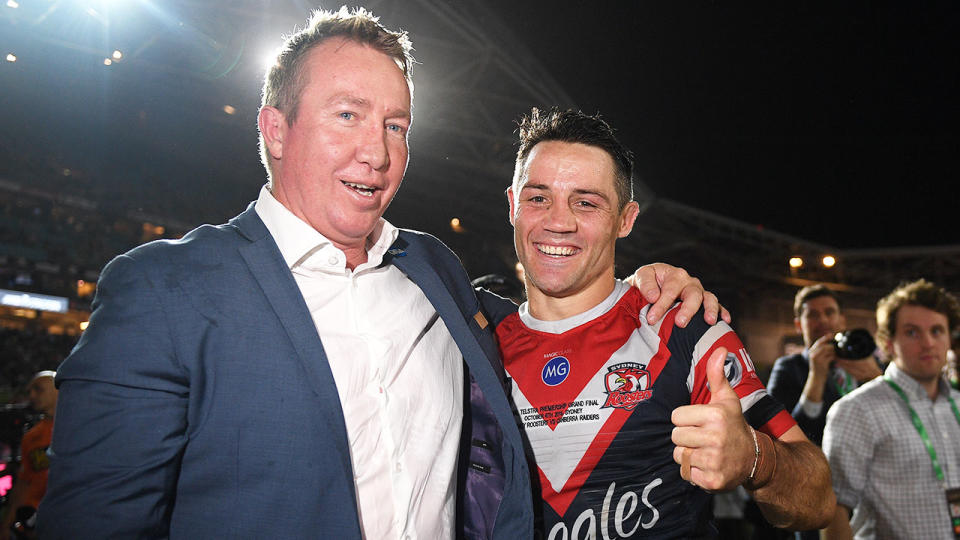 Cooper Cronk is seen here with Roosters coach Trent Robinson after winning the 2019 NRL grand final.