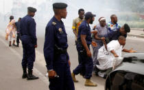 Riot policemen fire tear gas to disperse Catholic priest and demonstrators during a protest against President Joseph Kabila, organized by the Catholic church in Kinshasa, Democratic Republic of Congo January 21, 2018. REUTERS/Kenny Katombe