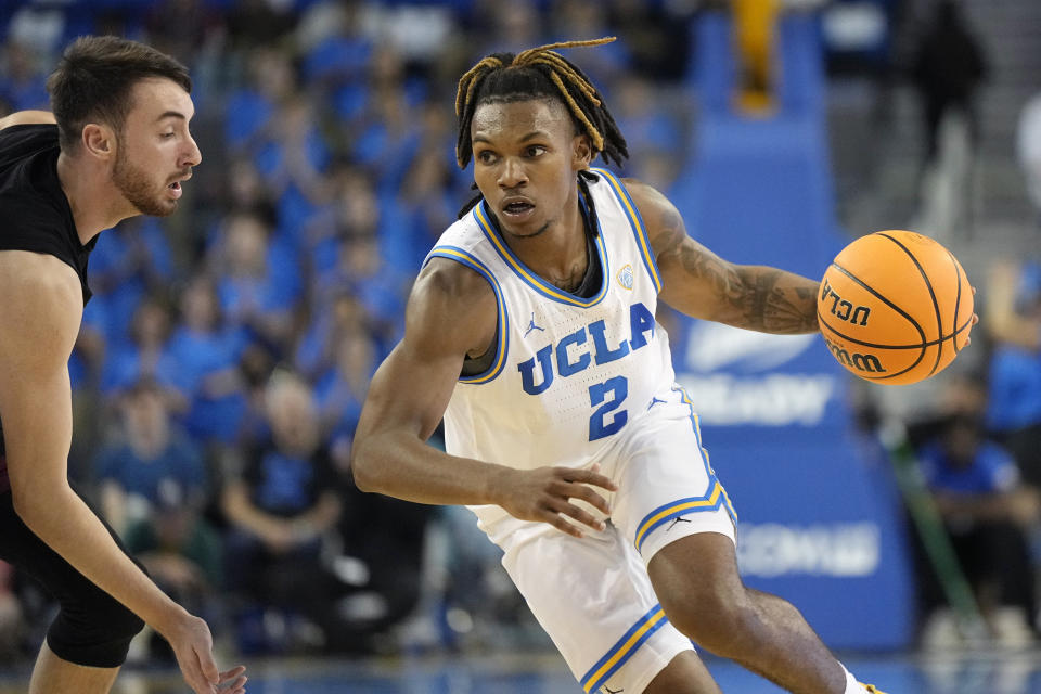 UCLA guard Dylan Andrews, right, drives past Lafayette guard Luka Savicevic during the second half of an NCAA college basketball game Friday, Nov. 10, 2023, in Los Angeles. (AP Photo/Mark J. Terrill)